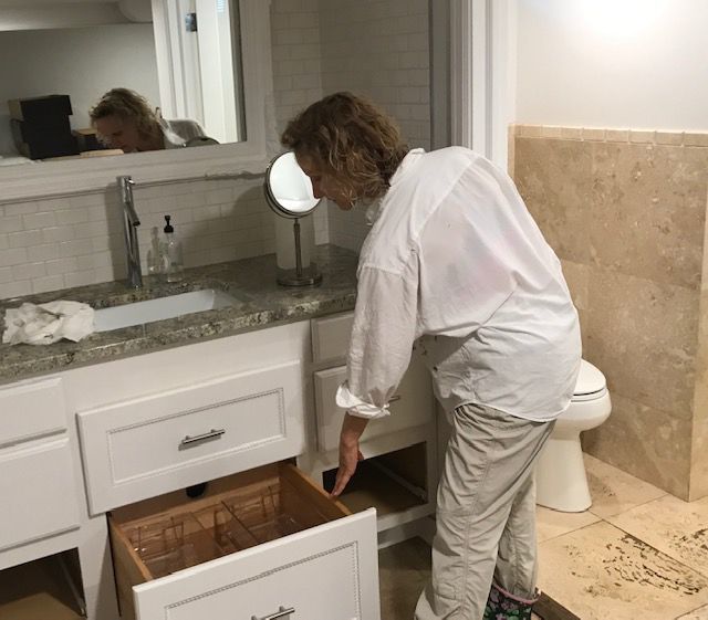 Natacha Nicholas checks damage caused by city sewage that backuped into her home
